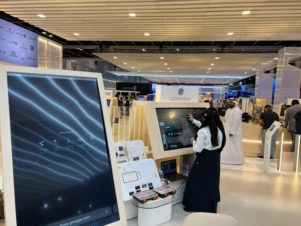 A visitor tries a touch screen in the exhibition hall at GITEX 2022 in Dubai